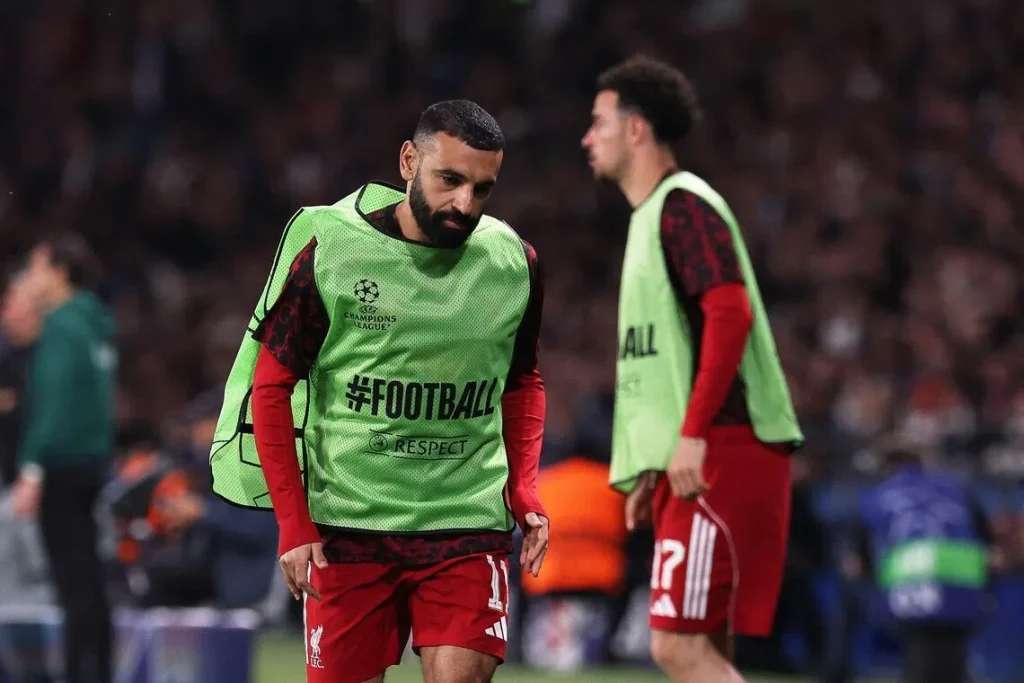 Salah (left) warmed up on the sidelines but was not fielded by Sloot in the match.